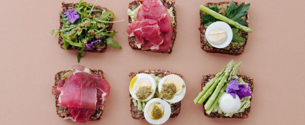 A top view of gourmet sandwiches with fresh ingredients presented in a flat lay style.