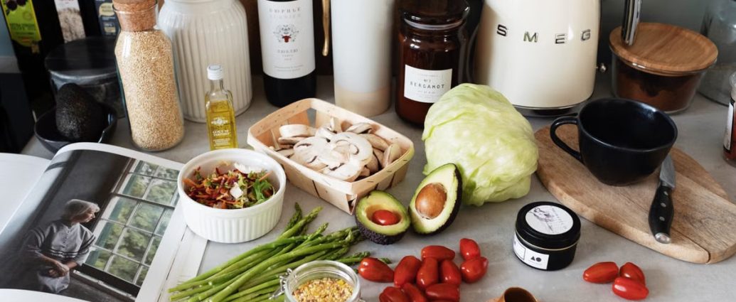 A variety of fresh ingredients and kitchen tools for preparing a healthy meal.